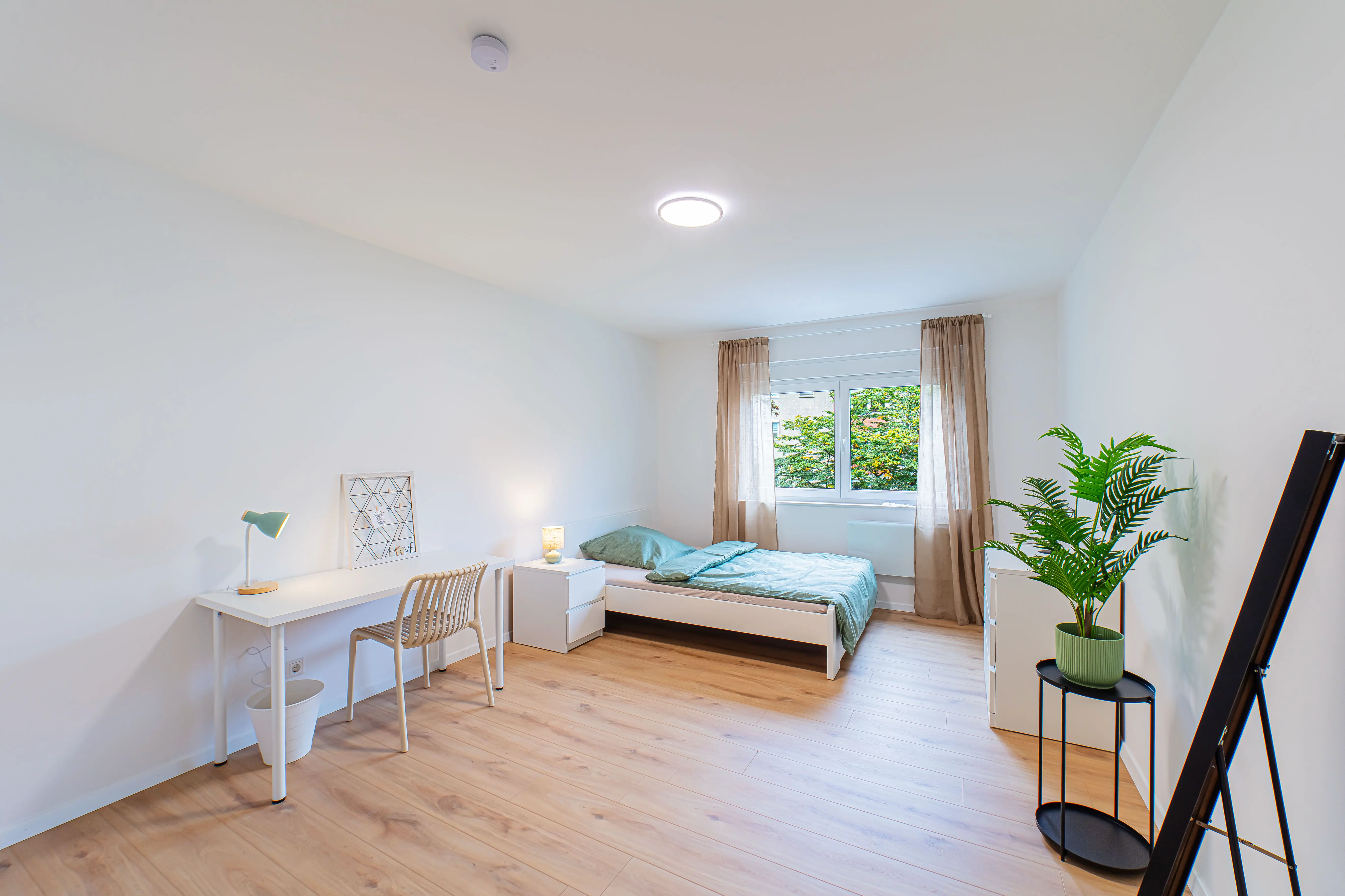 Modernes Schlafzimmer mit Bett, Schreibtisch und Stuhl